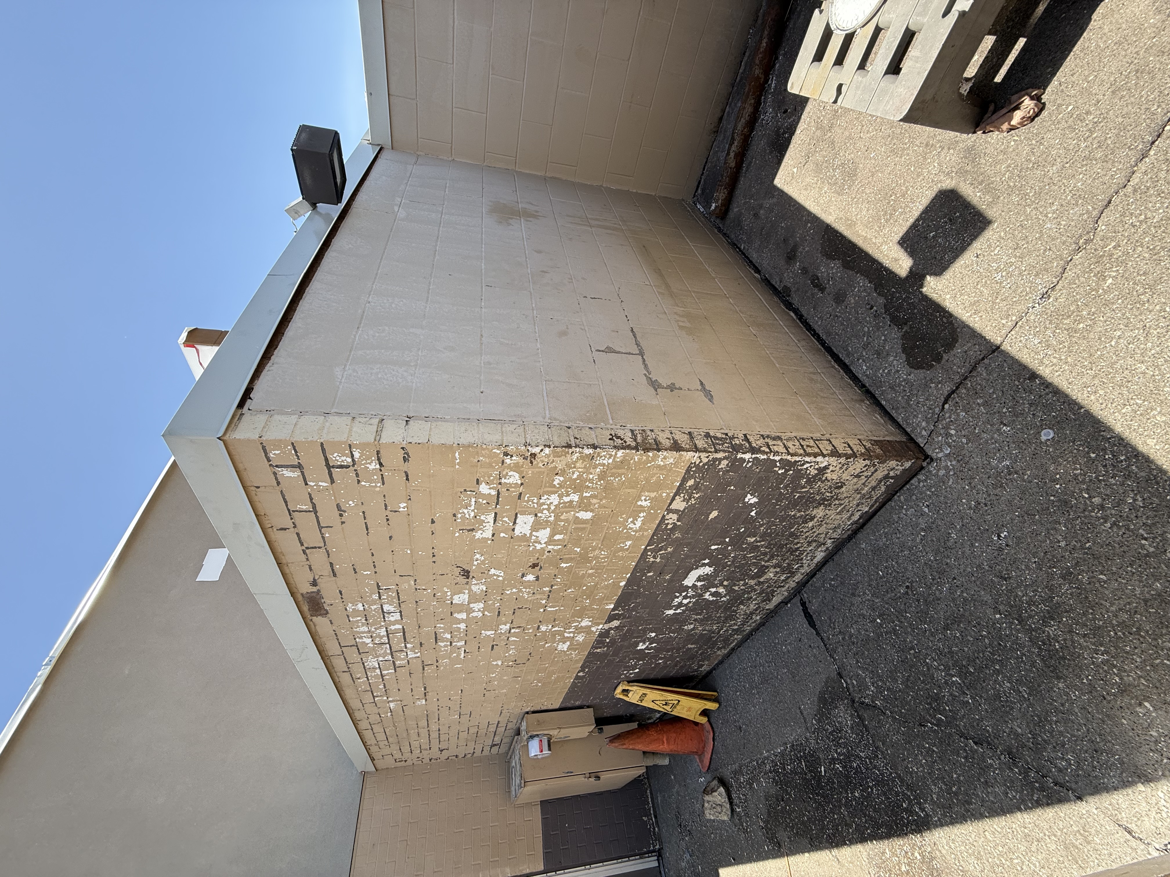 Before: Commercial brick and stucco exterior